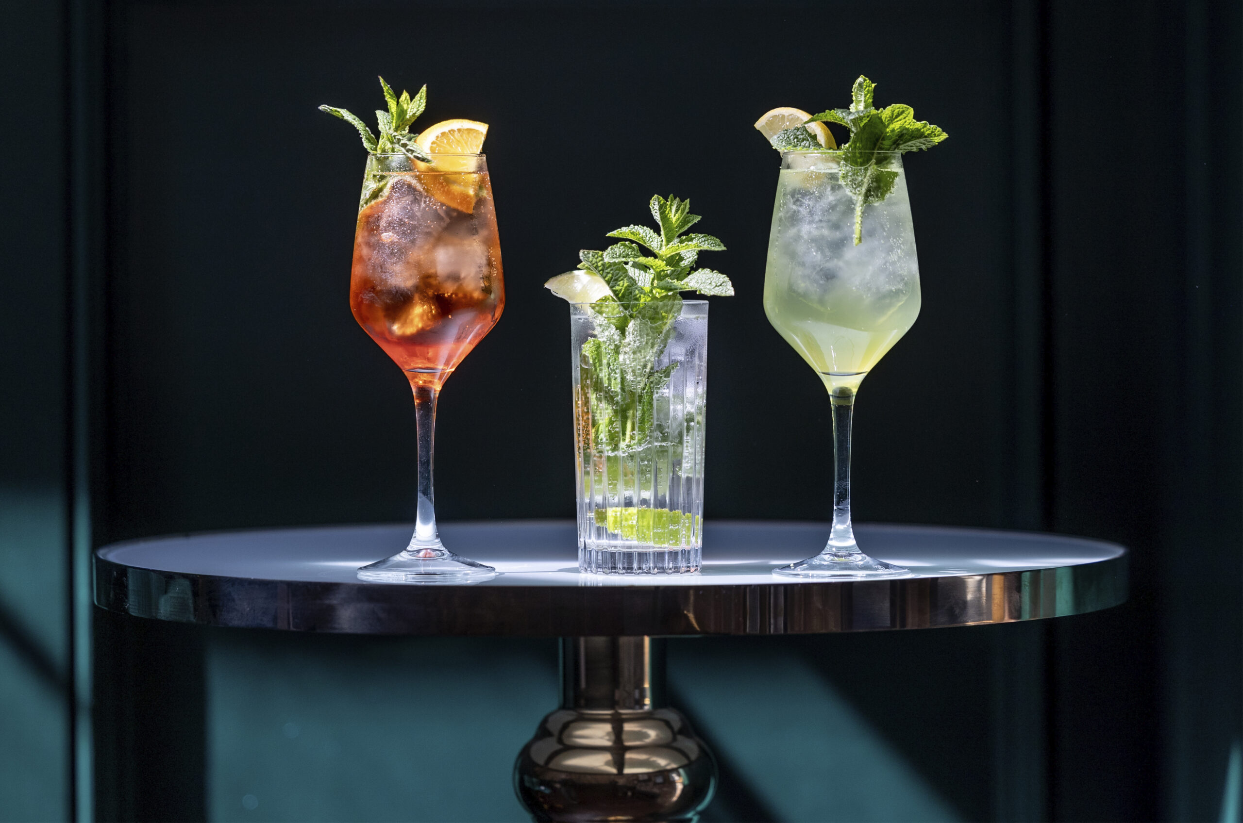 Three garnished cocktails on a table, drinks served at the Hawksley Bar, Dalton Old Pump House