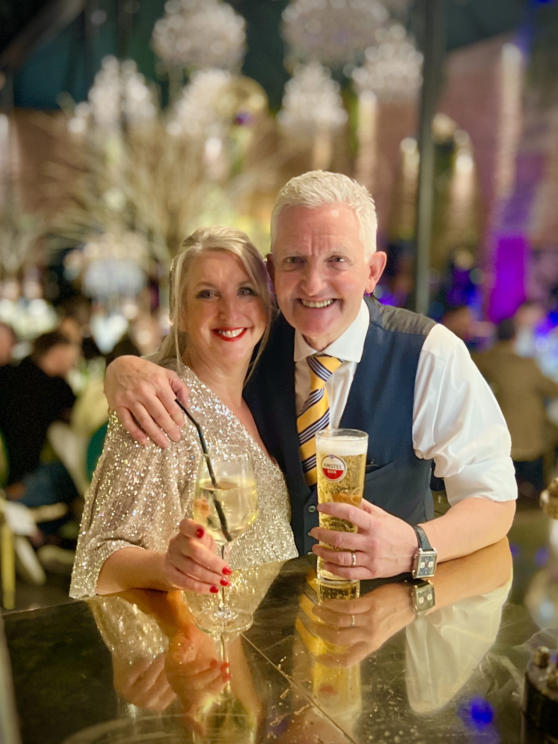 Vikki and Ian, owners of Dalton Old Pump House wedding venue, celebrating beneath the crystal chandeliers