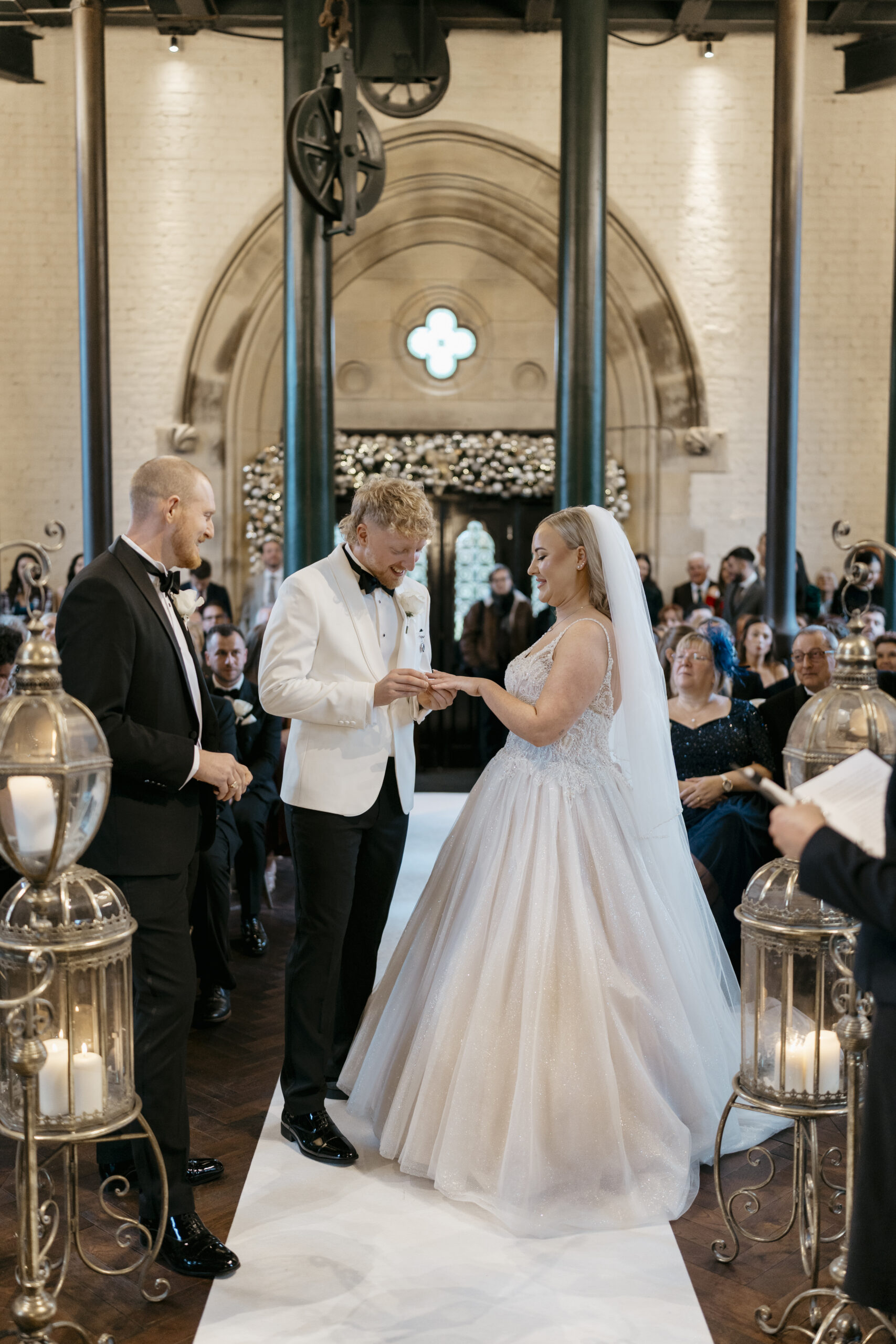 Bride and groom exchanging rings during a wedding ceremony at Dalton Old Pump House, County Durham